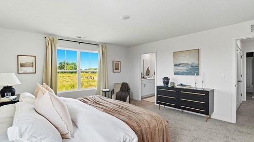 furnished primary bedroom with double window