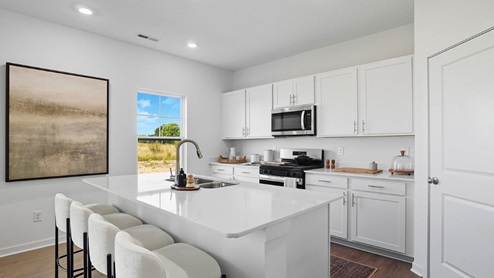 white cabinets, built in island, stainless steel appliances, single window