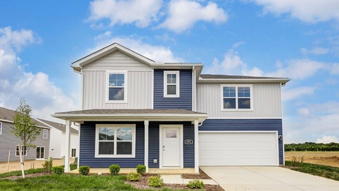 two story home with blue and white siding, covered front porch and two car garage