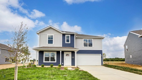 two story home with blue and white siding, covered front porch and two car garage angle