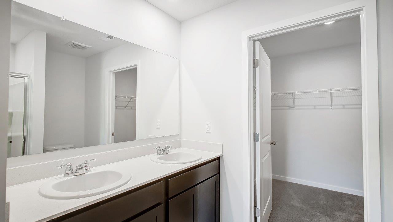 Owner’s ensuite in a new build home offers function and style with a walk-in closet, spa-like ensuite