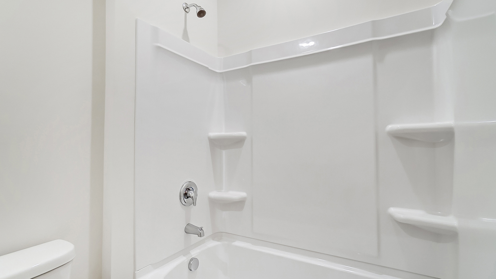Family bathroom with stylish vanity, mirror, polished fixtures, cabinets, tub-shower combo in Lansdowne Farms