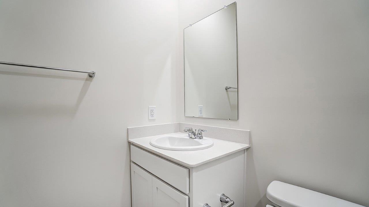 Second bath with built-in tub-shower combo, vanity, sink, lighting, stylish finishes in Lansdowne Farms