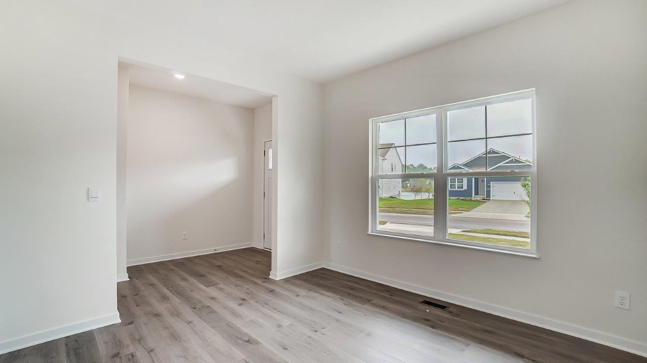 Entry-adjacent dining room in Lansdowne Farms new home by D.R. Horton with natural light