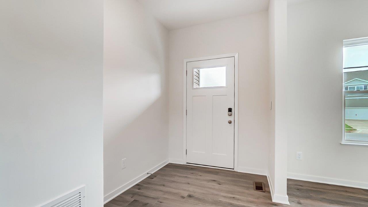 A foyer, entry hall inside front door, next to office, or sitting room adding a welcoming front, direct line of sight to home