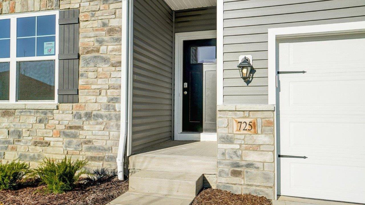 Front Covered Door and porch of this new residence brings you home with well-crafted and designed living areas