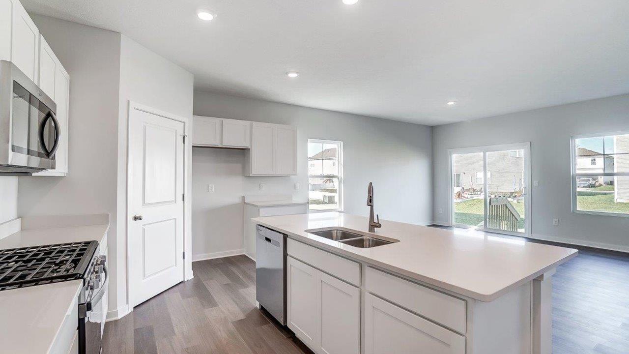 New appliances included, and a larger kitchen island, a sink, seating anchor our kitchen, pantry, near dining, living rooms