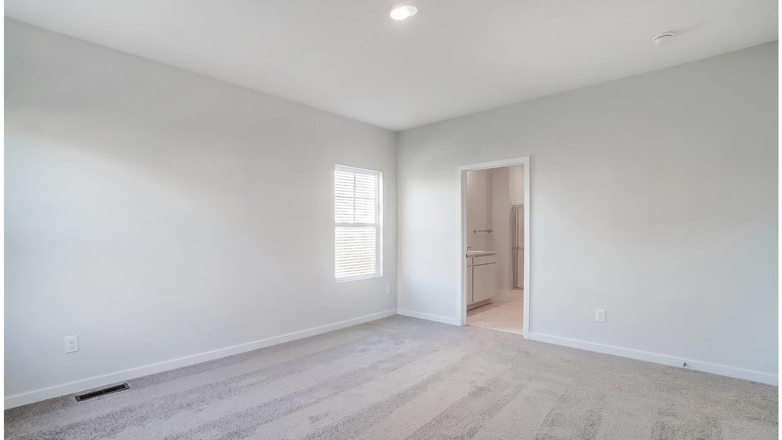 Primary bedroom designed with privacy and space in mind with a flow into a spa-inspired ensuite bathroom and walk-in closet