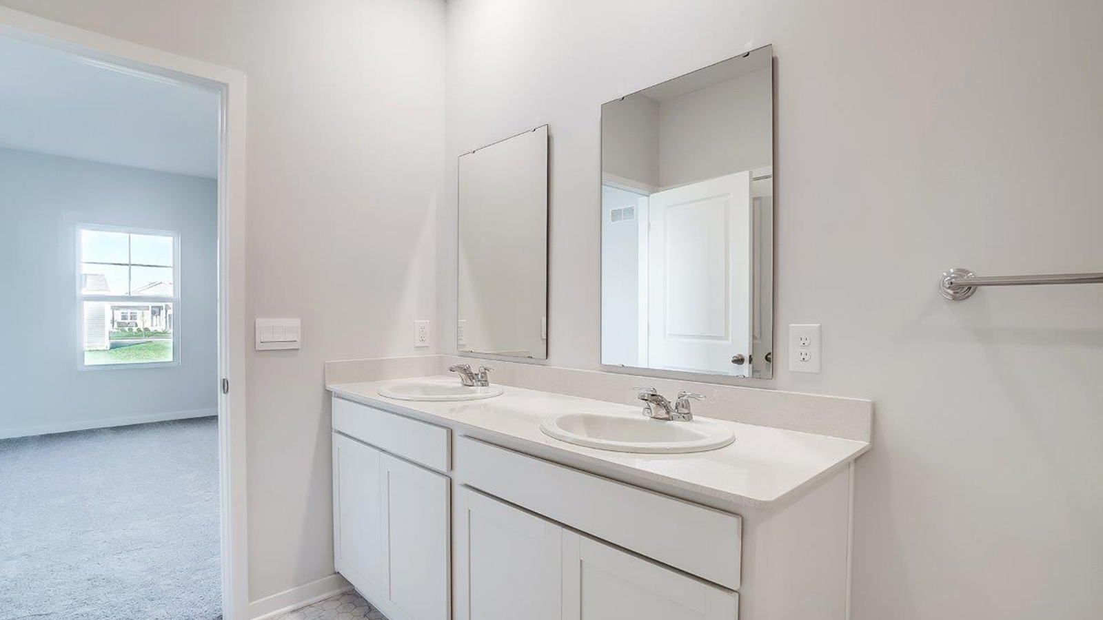 Interior view of walk-in closet in the primary bedroom and spa-inspired ensuite in Lansdowne Farms  new home by D.R. Horton