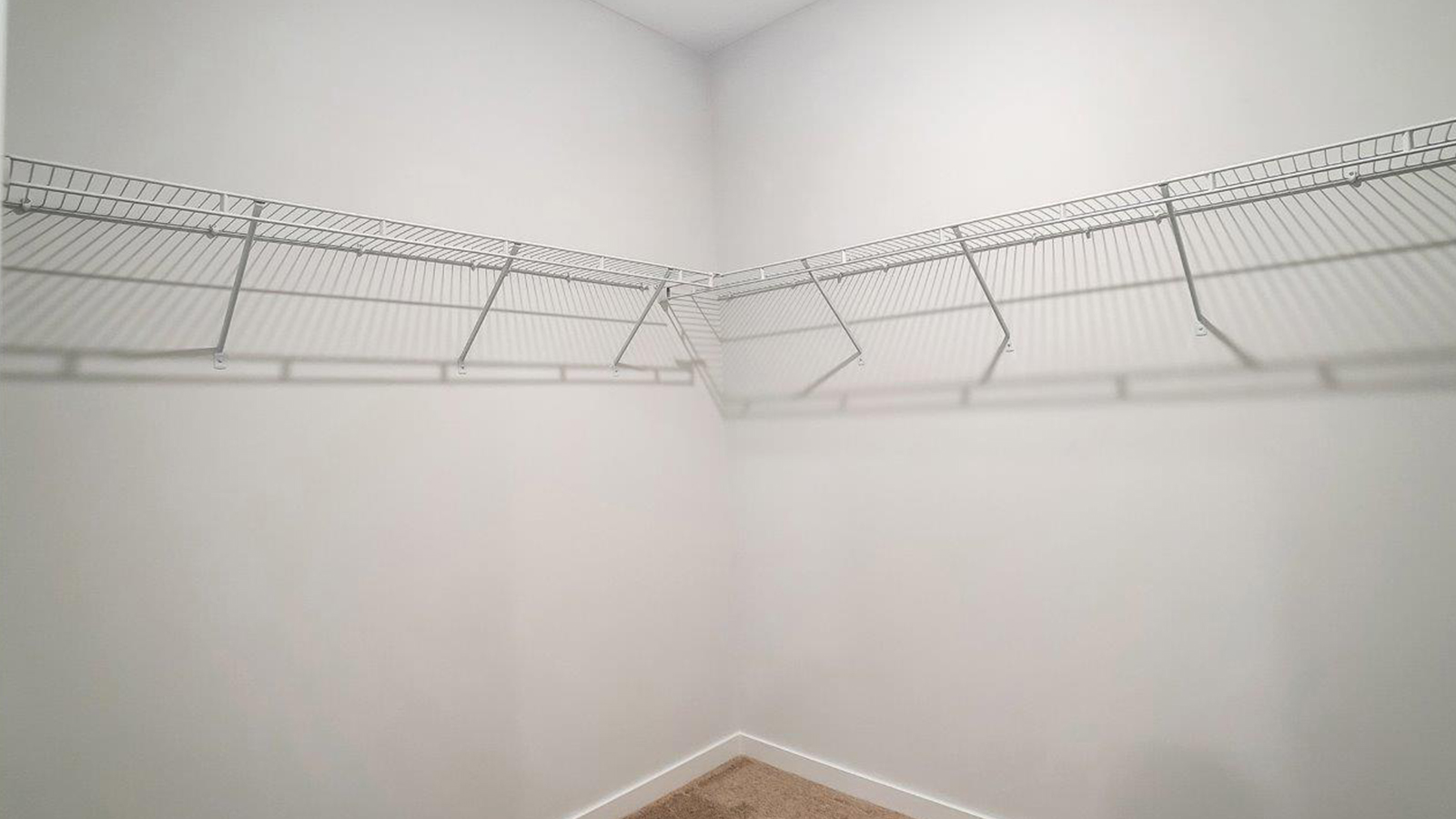 Primary suite walk-in closet in Lansdowne Farms  new home with built-in shelving and generous storage