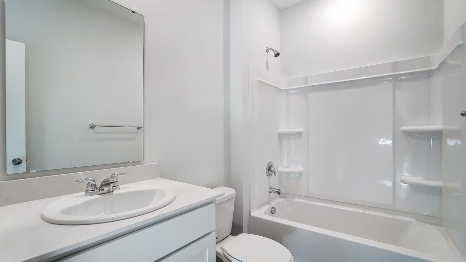 Sleek family-guest bath with single sink, mirror, cabinets, and shower-tub combination at Lansdowne Farms
