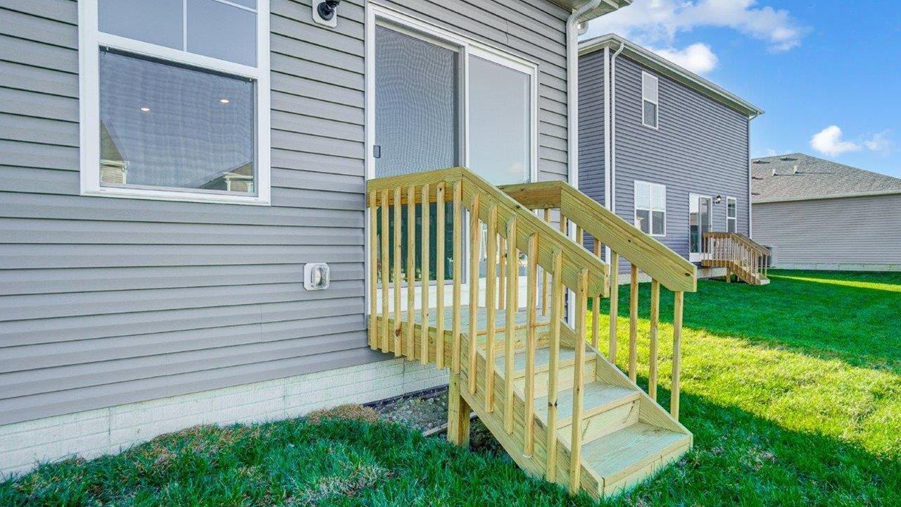 Backyard deck offers outdoor access for seating, grill setup, and a transition from indoor to outdoor living