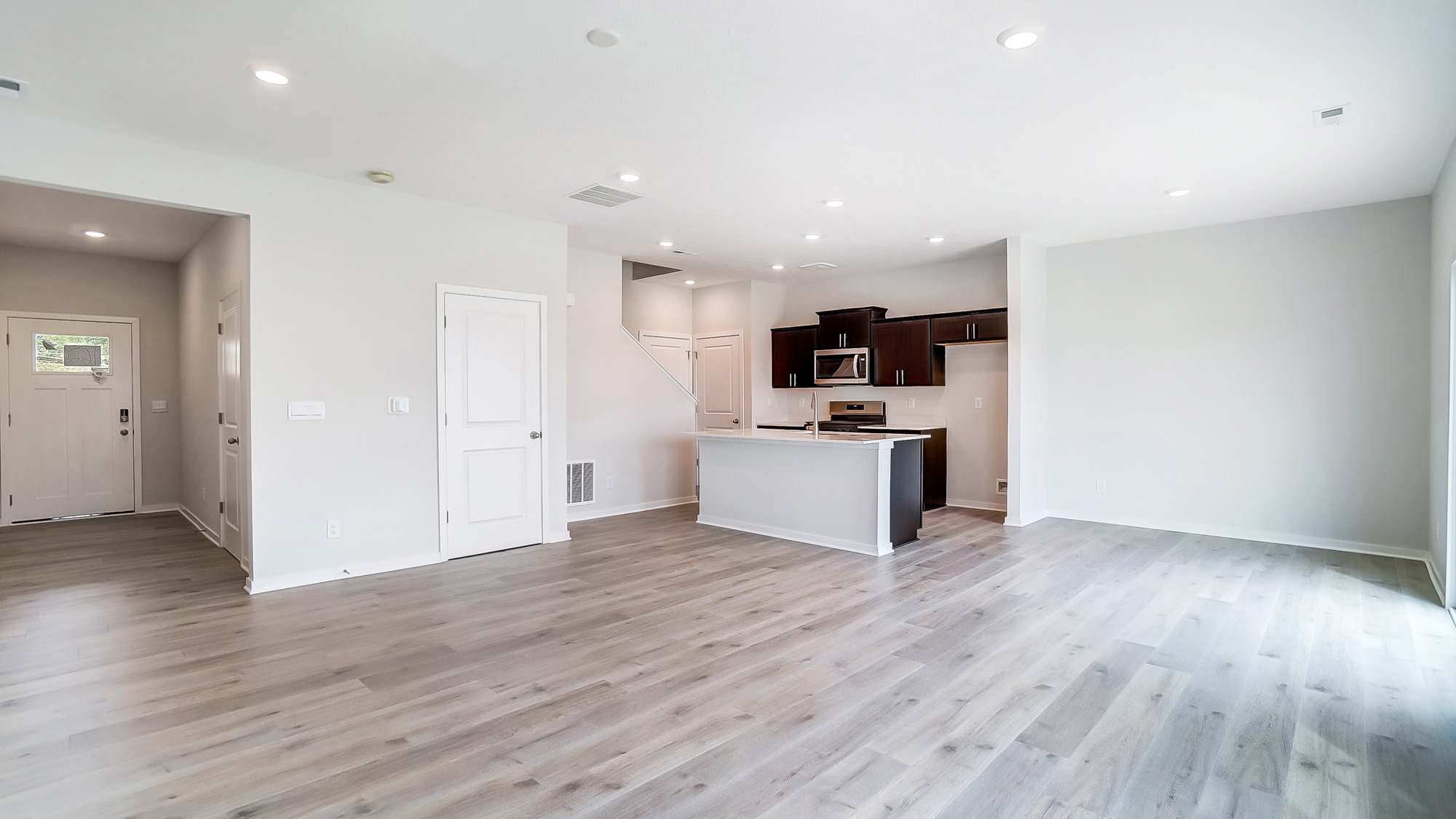 Living room view of the dining area and the kitchen.