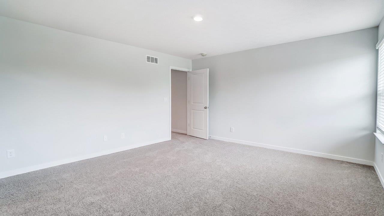 Bedroom with a closet and entrance to the hallway.