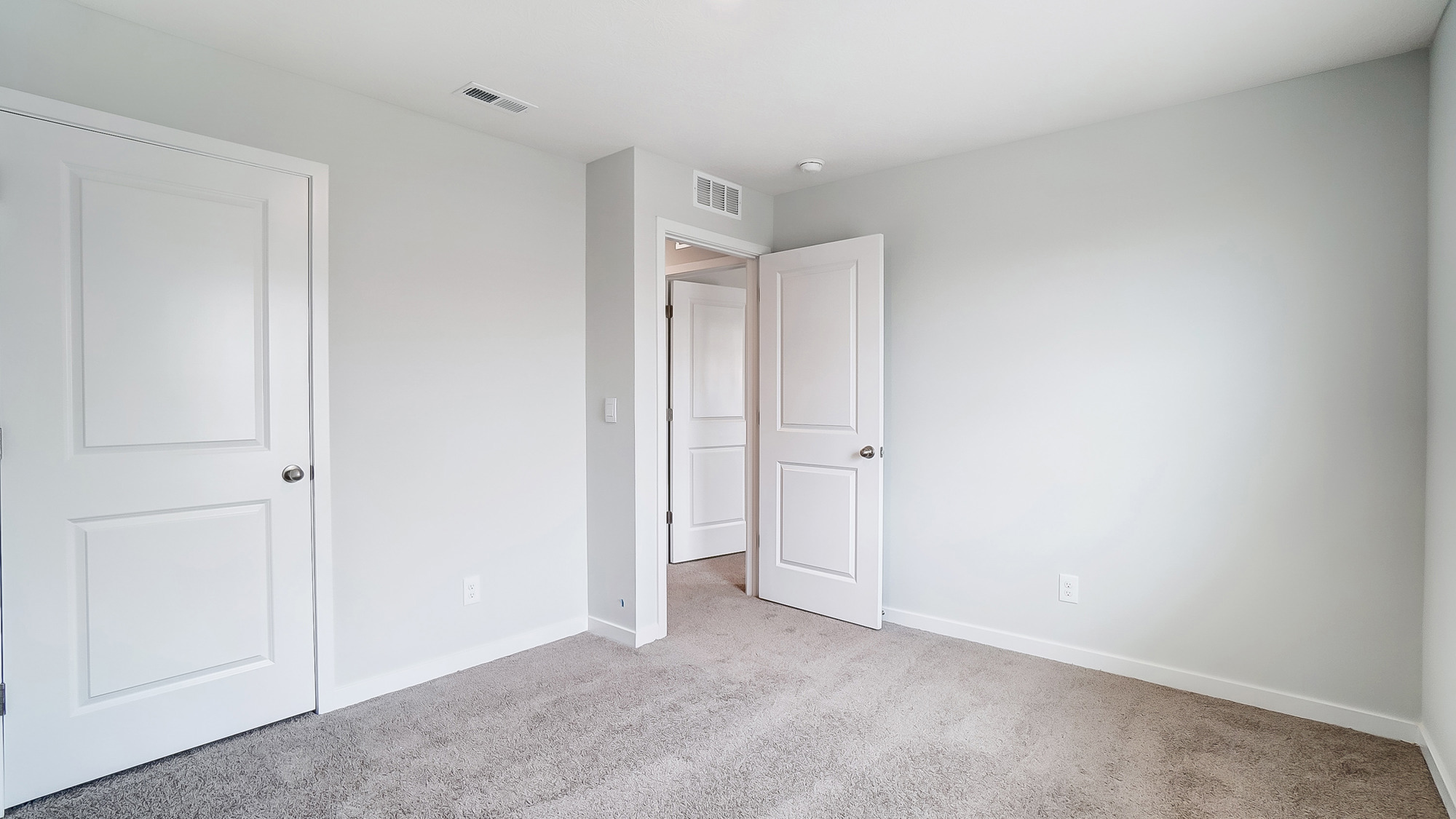 Bedroom with a closet and entrance to the hallway.