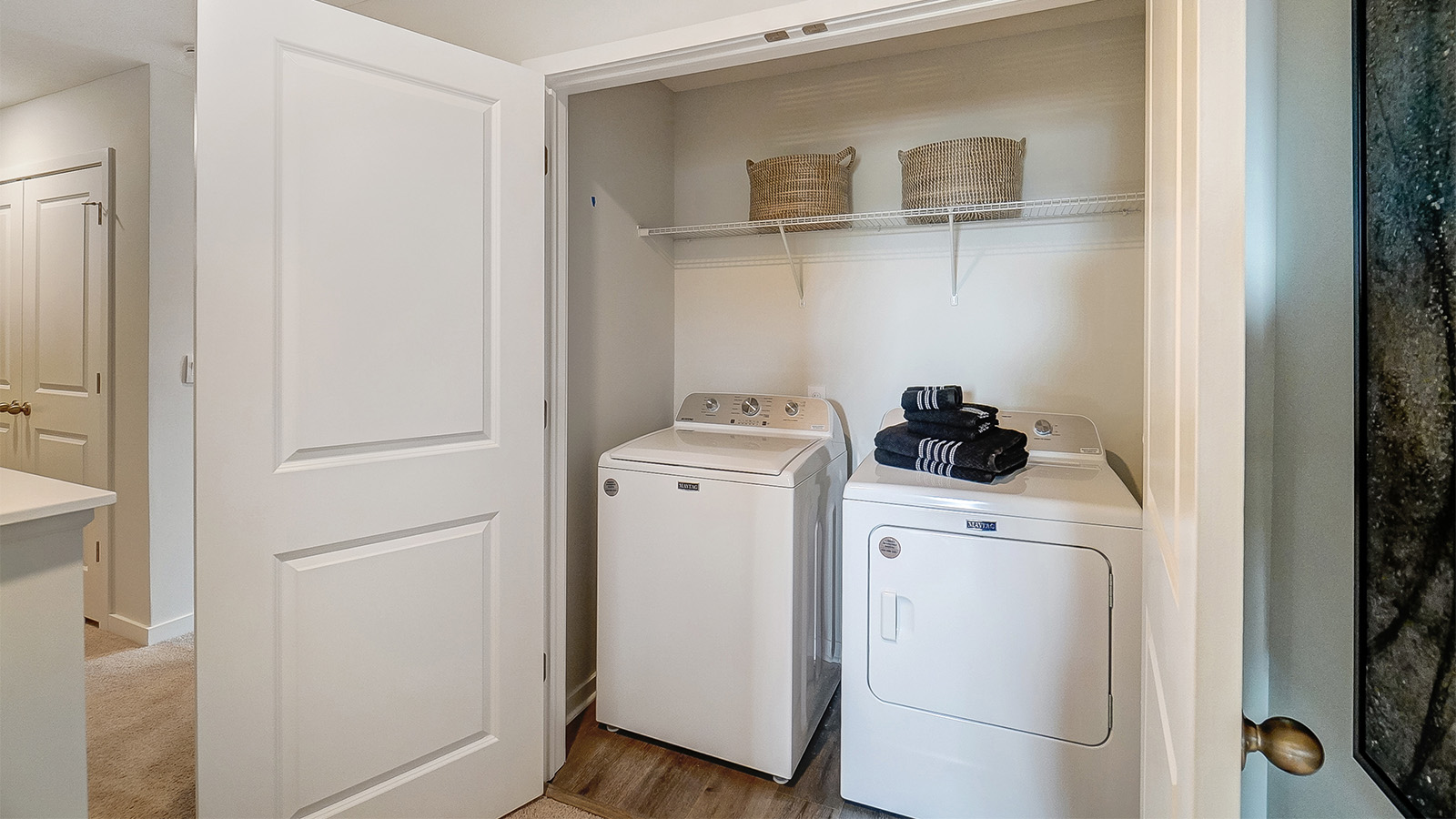 laundry room with washer, dryer and wire shelving
