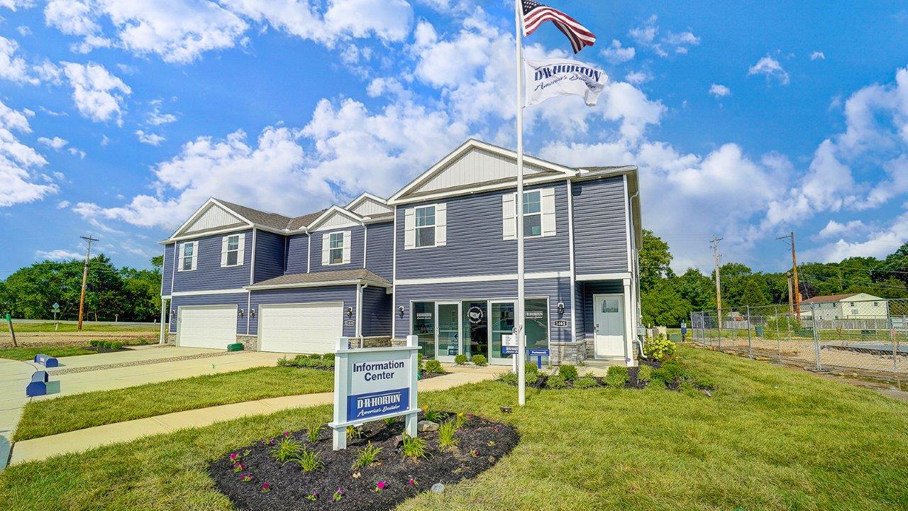 two story, 3-unit townhome building with blue siding and two car garages