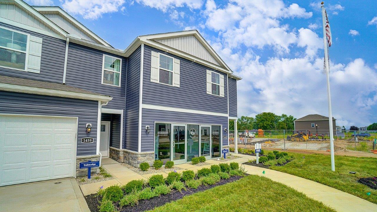 two story, 3-unit townhome building with blue siding and two car garages