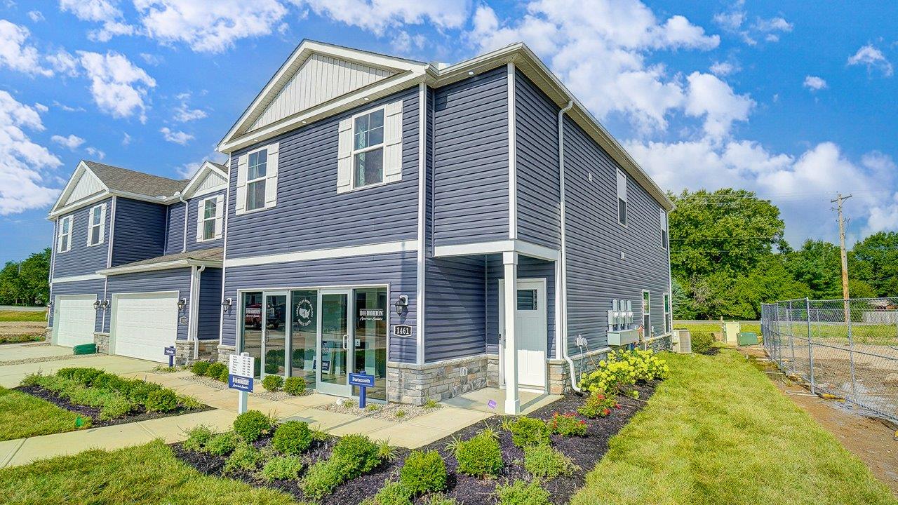 two story, 3-unit townhome building with blue siding and two car garages