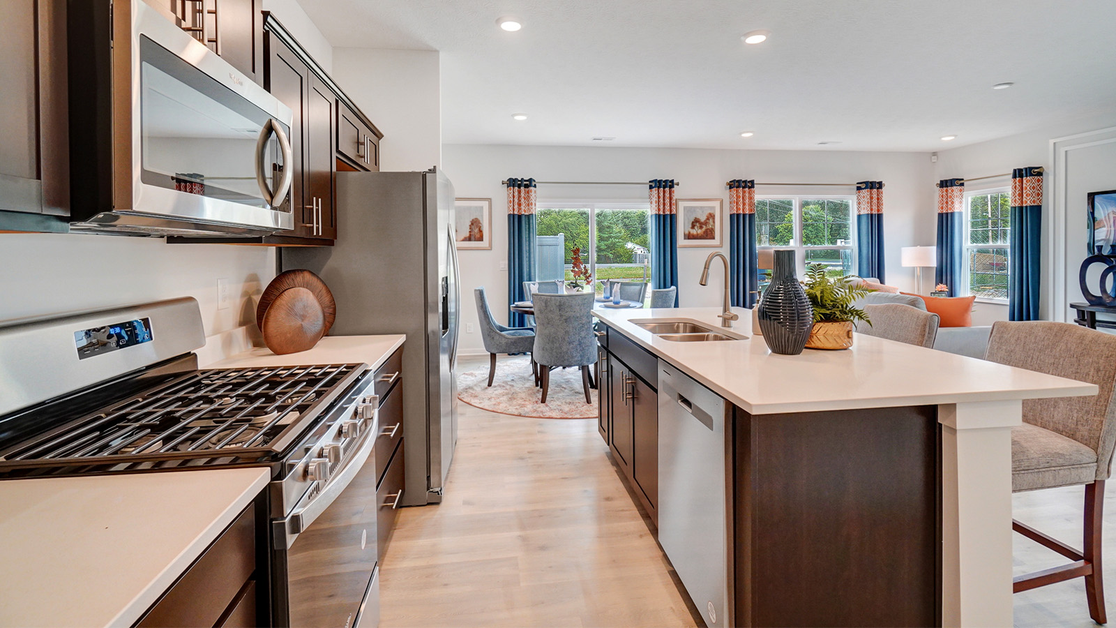 brown cabinets, hard surface appliances, built in island