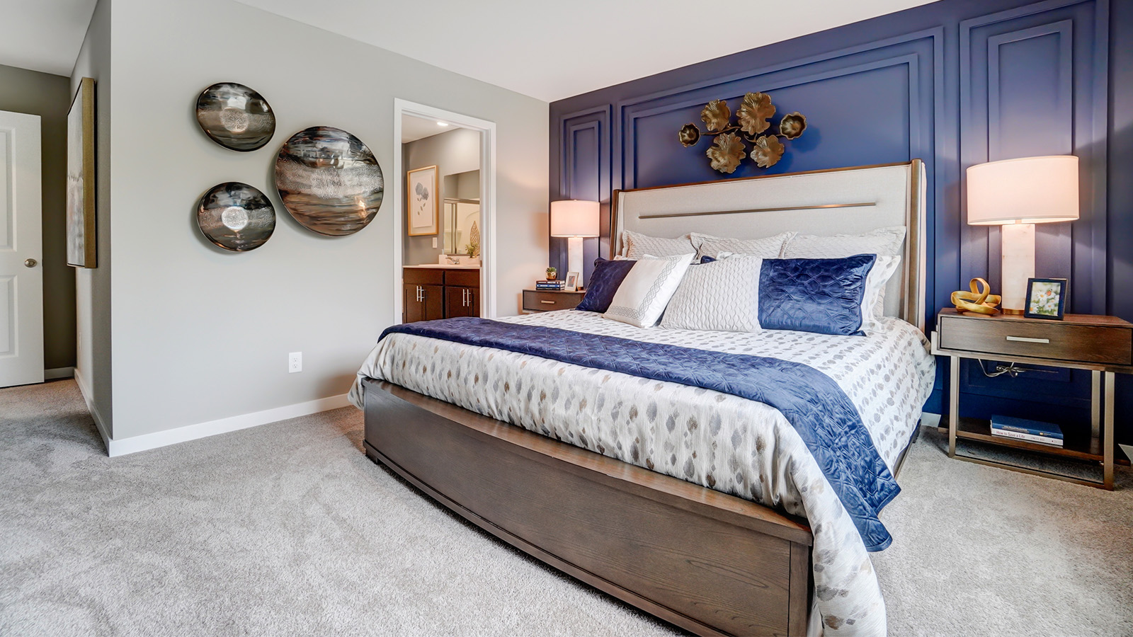 primary bedroom with queen bed and night stands, ensuite bath