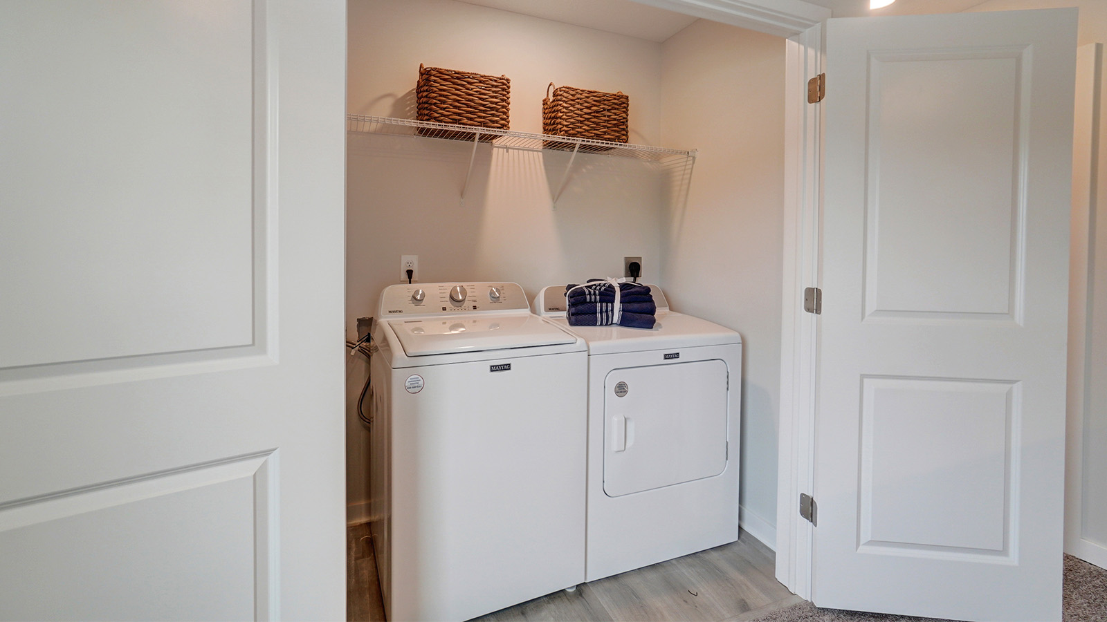 laundry room with wire shelving, washer and dryer