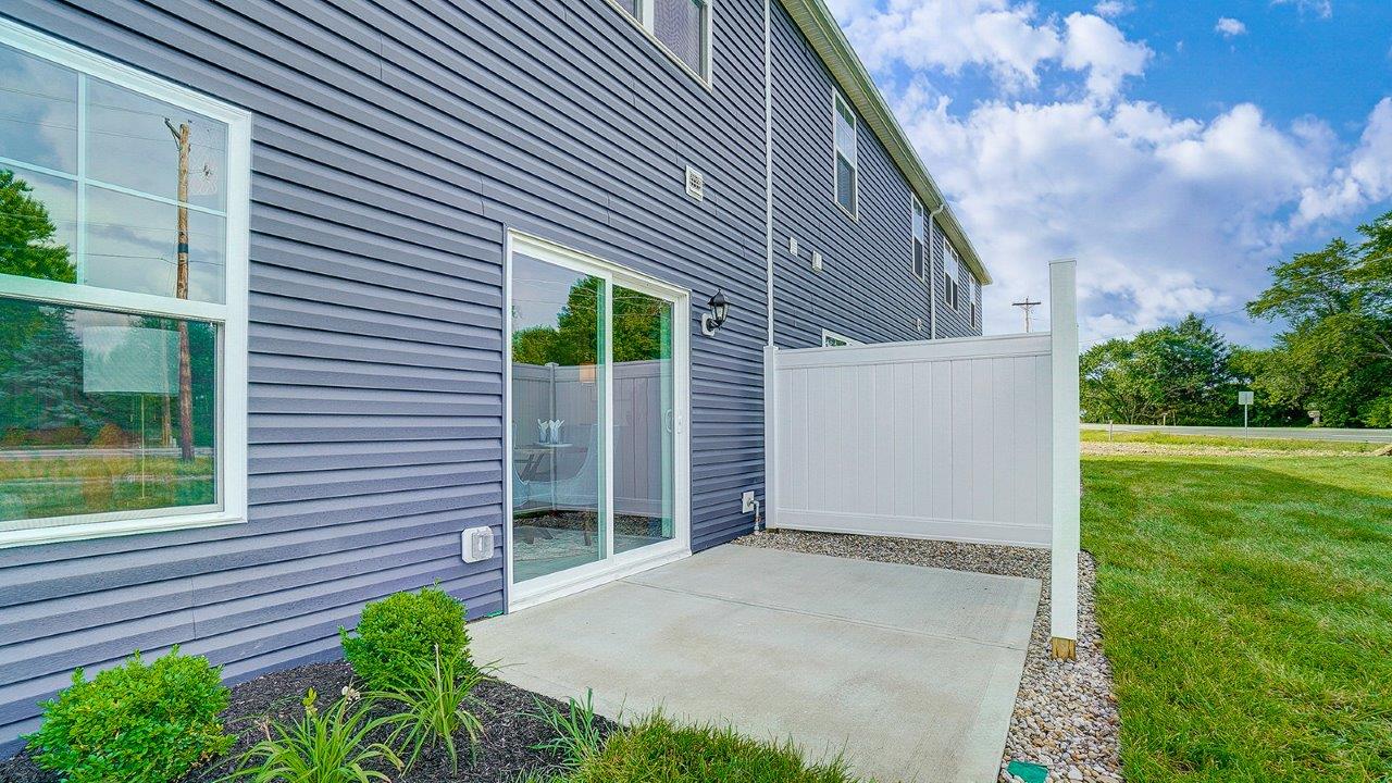 rear sliding door with partially fenced patio