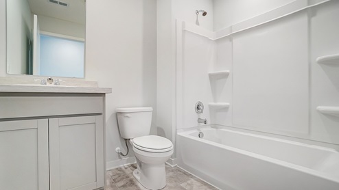 second full bath with single vanity, toilet and tub