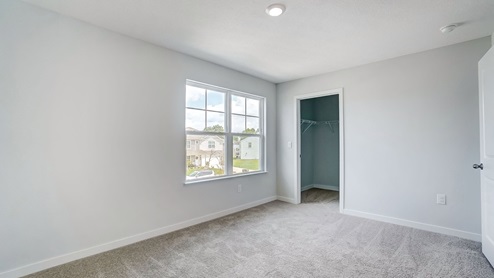 third bedroom with double window and walk in closet