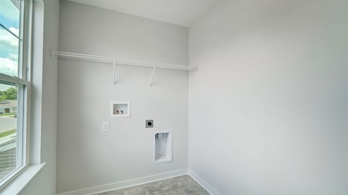 laundry room with wire shelving and single window