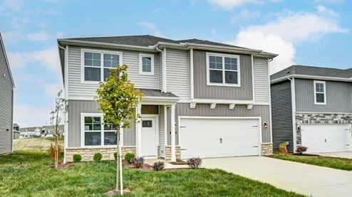 two story home with grey siding, covered entry and two car garage
