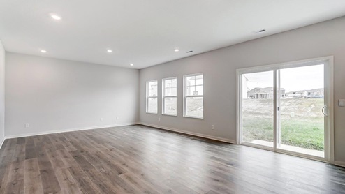 great room with three single windows and rear sliding door