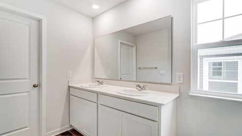 ensuite bath with double vanity and single window