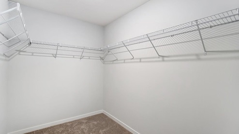primary walk in closet with wire shelving