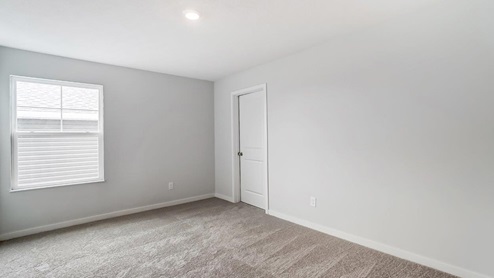 third bedroom with single window and closet