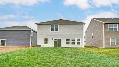 two story home with grey siding rear exterior