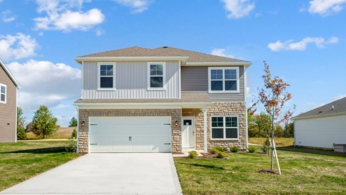 two story home with grey siding, partial stone front, covered entry, two car garage