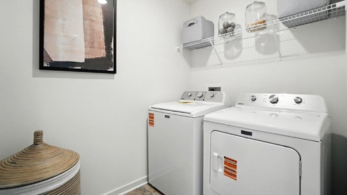 laundry room with wire shelving, washer and dryer