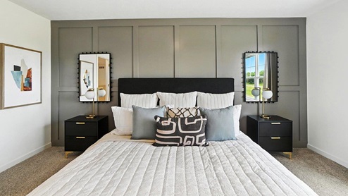 furnished primary bedroom with board and batten accent wall
