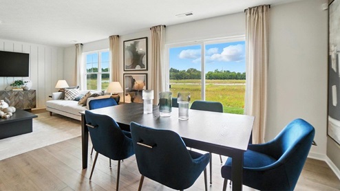 dining space with table, chairs and rear sliding door