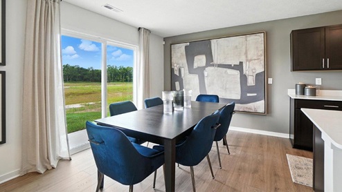 dining space with table, chairs and rear sliding door