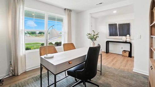 furnished flex office with desk and chairs and double window