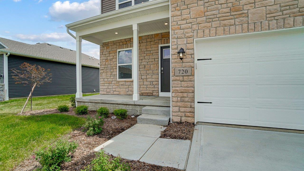 Front exterior of a two story home with a two car garage