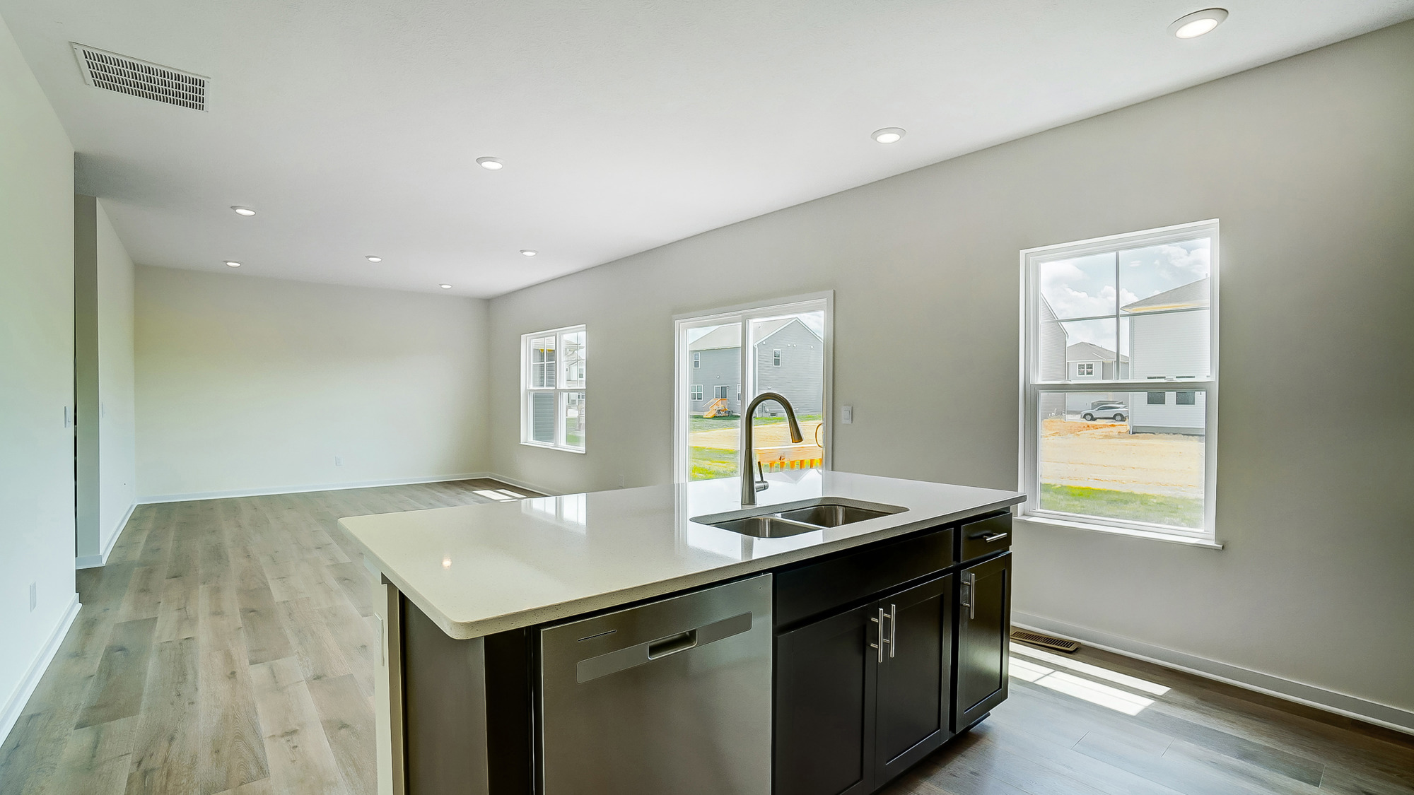 kitchen with brown cabinetry, large island and stainless steel appliances