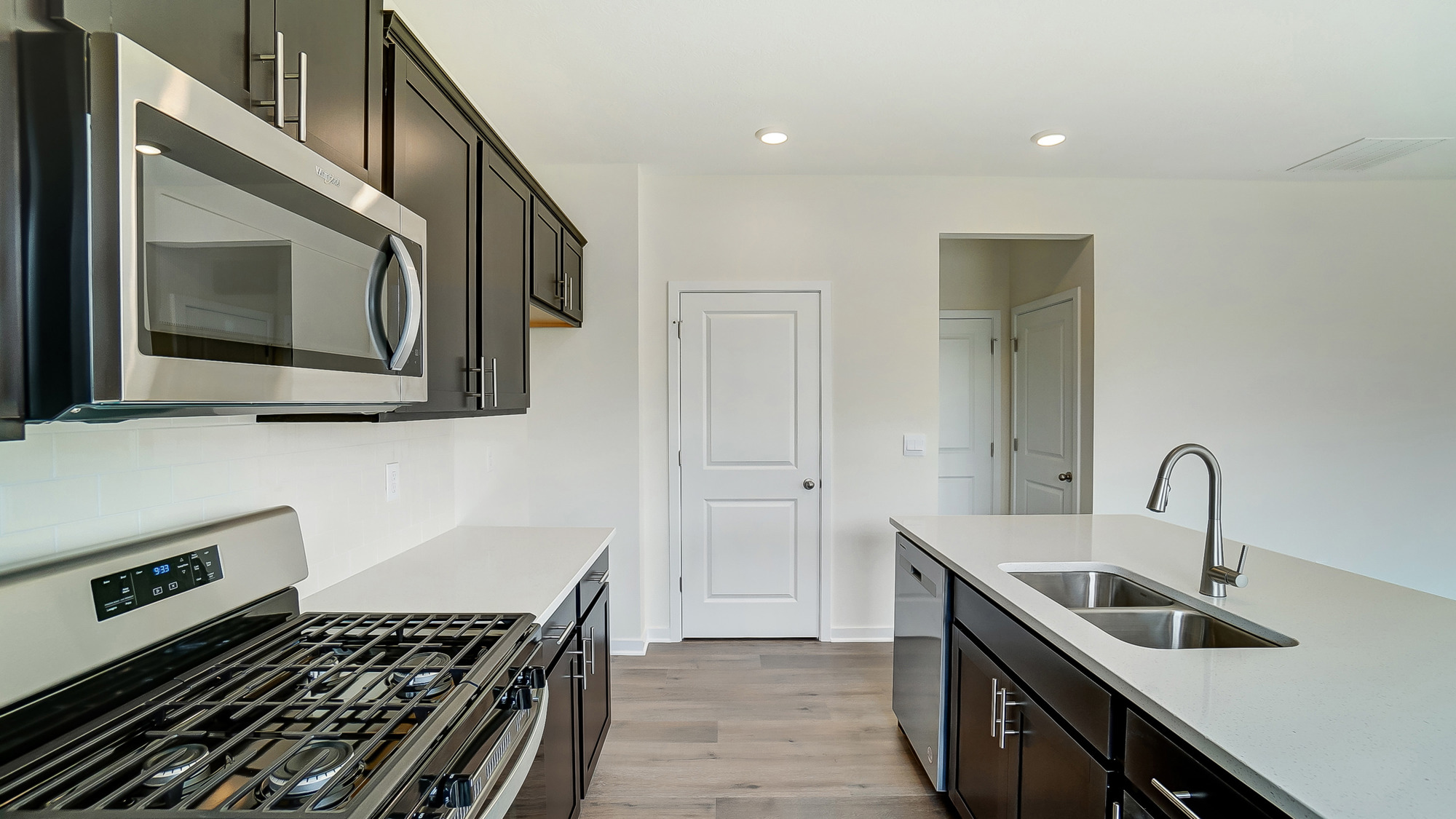 kitchen with brown cabinetry, large island and stainless steel appliances
