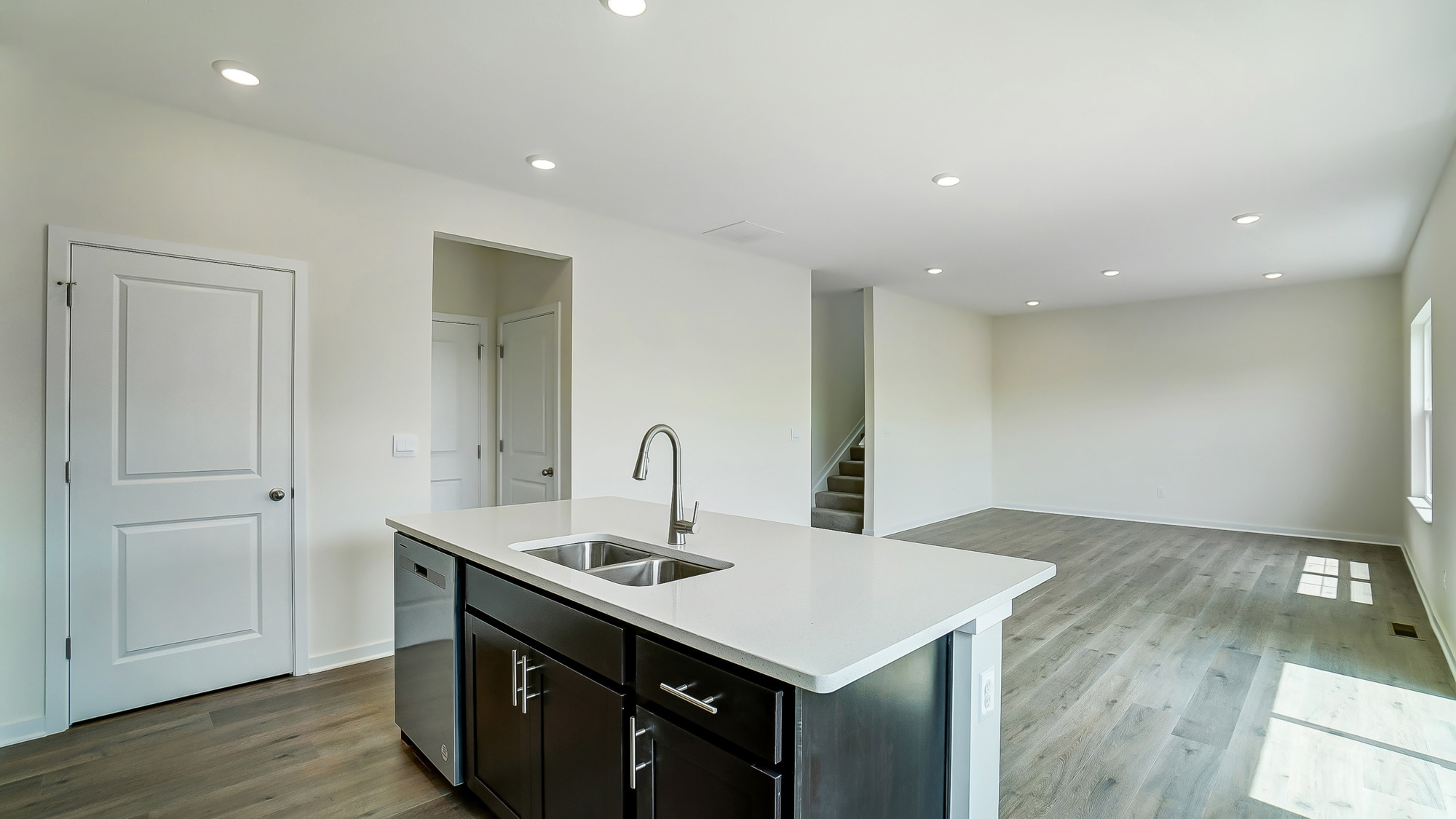 kitchen with brown cabinetry, large island and stainless steel appliances