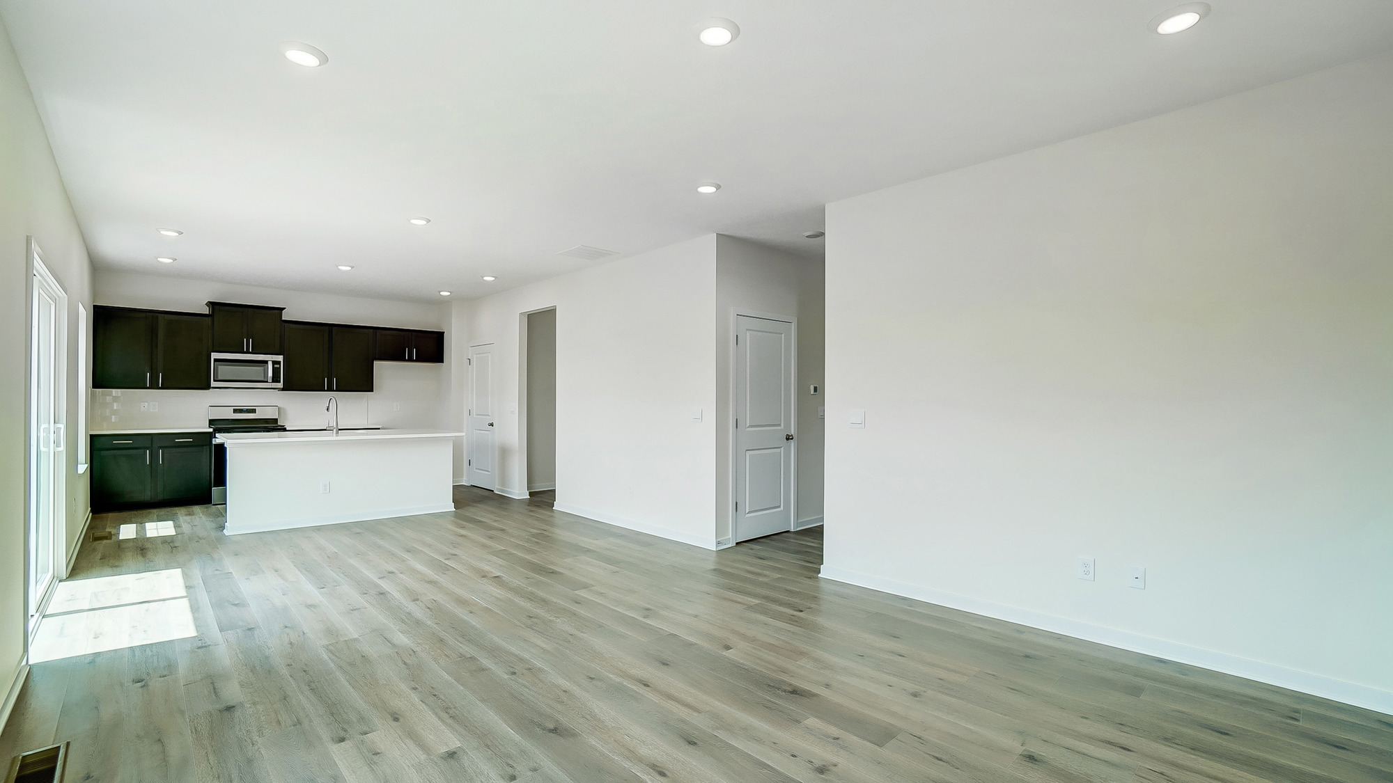 Open concept first floor with the living room and kitchen next to each other