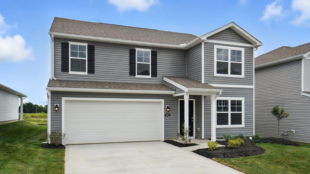 two story home with grey siding, covered entry and two car garage