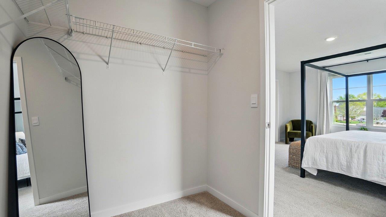 spacious walk in closet with built in shelves