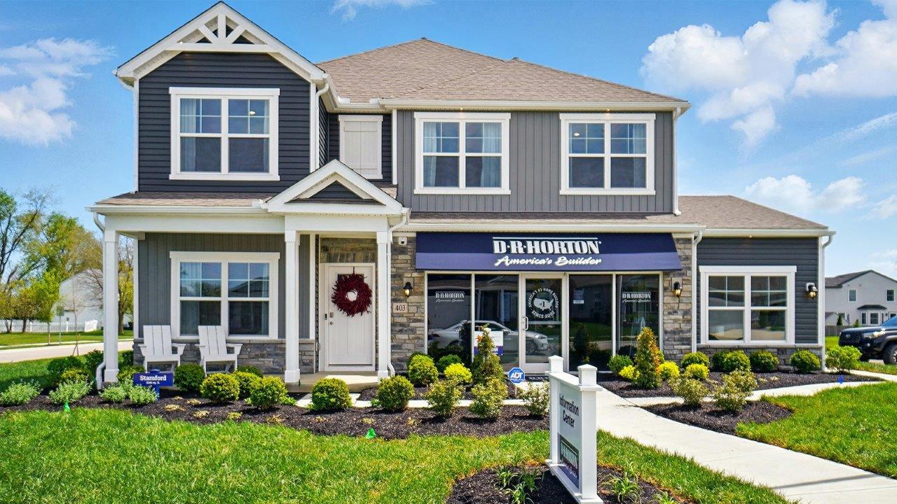 Front exterior of a Stamford model home featuring blue and gray siding
